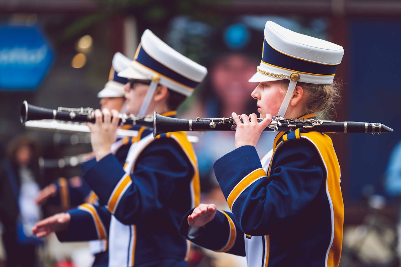 Marching band in uniform playing clarinets during a parade in Victoria, BC.